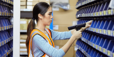 Woman in a warehouse using vendor managed inventory services from Agilix Solutions