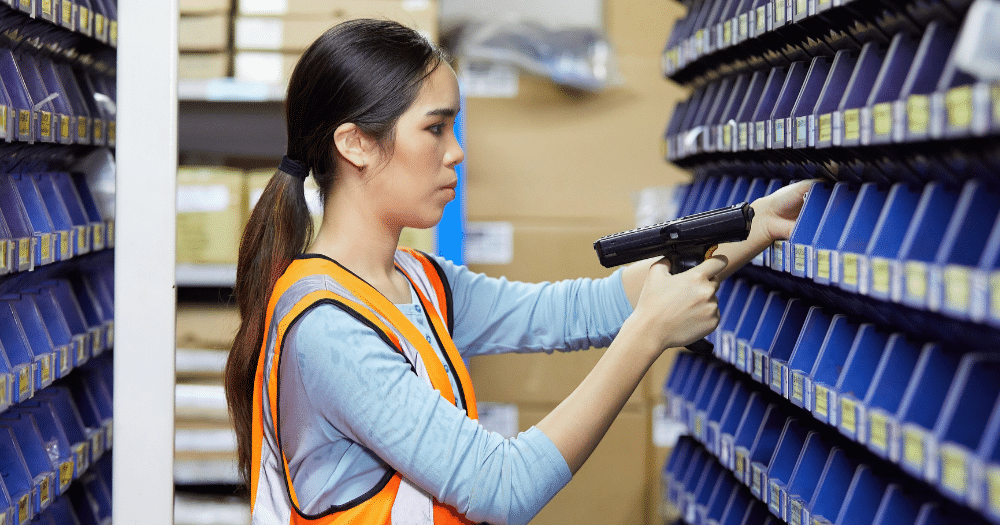 Woman taking advantage of vendor managed inventory in a warehouse. 