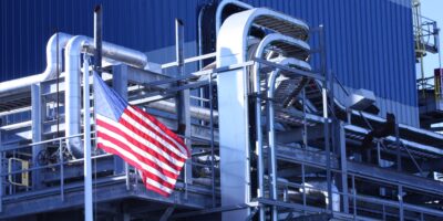 Build America/Buy America image of American flag outside a U.S. factory.